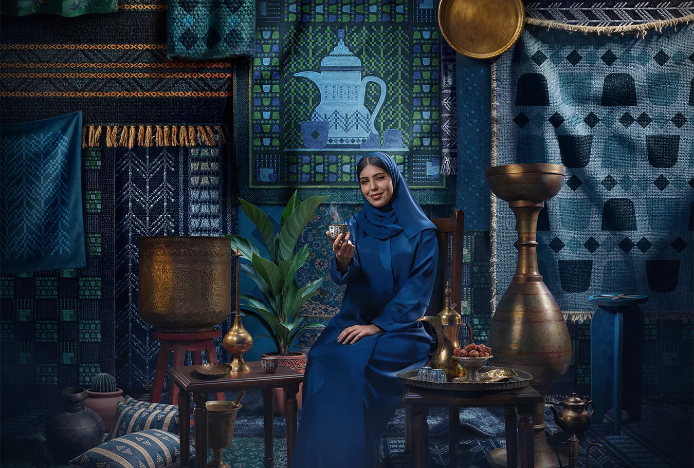 Saudi National Day scene with a woman serving Arabic coffee beside traditional decor